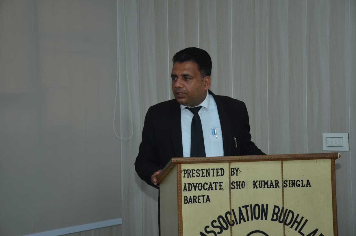 Addressing the Bar Association at podium